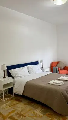 a bedroom with a bed with two folded towels on it at Sunny Apartment with Stunning San Pietro View in Rome