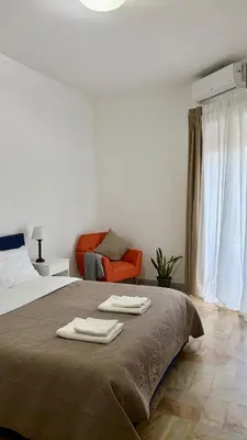 a bathroom with a white sink and a mirror at Sunny Apartment with Stunning San Pietro View in Rome