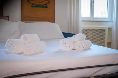 a pile of towels sitting on top of a bed at Vatican Museum apartment by Varental in Rome