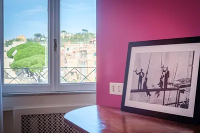 a picture of two men on a table in a room with a window at Vatican Museum apartment by Varental in Rome