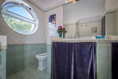 a bathroom with a sink and a toilet and a window at Vatican Museum apartment by Varental in Rome