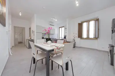 a kitchen and dining room with a table and chairs at Da zia Maria in Rome