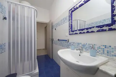 a bathroom with a sink and a shower and a mirror at Da zia Maria in Rome