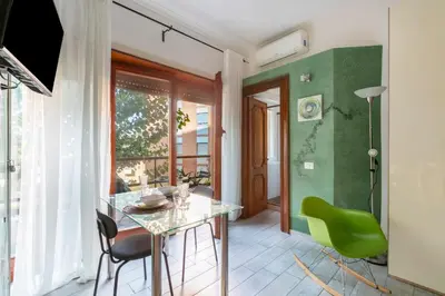 a kitchen with a table and chairs in a room at Vaticano 44 by Hili in Rome