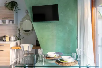 a dining room with a glass table and a green wall at Vaticano 44 by Hili in Rome