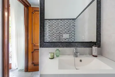 a bathroom with a sink and a mirror at Vaticano 44 by Hili in Rome