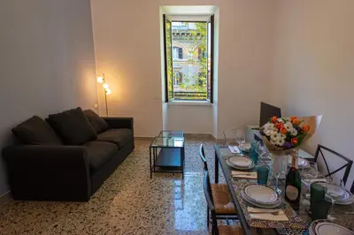 a living room with a couch and a table at Colosseo Apartment 183 in Rome