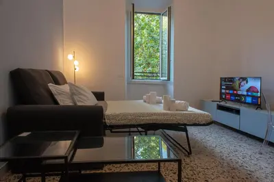 a living room with a couch and a tv at Colosseo Apartment 183 in Rome