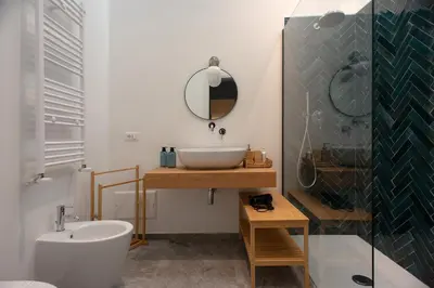 a bathroom with a sink and a mirror and a tub at Colosseo Apartment 183 in Rome