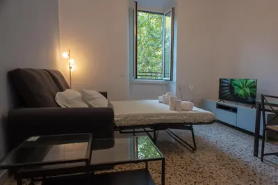 a living room with a couch and a tv at Colosseo Apartment 183 in Rome