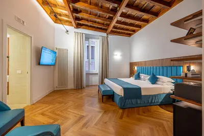 a hotel room with a bed and a tv at AGH - Capranica in Rome