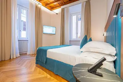 a hotel room with a bed and a table at AGH - Capranica in Rome