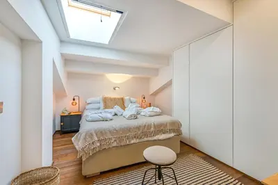 a bedroom with a bed and a skylight at Skylife Tiber Luxury Penthouse in Rome