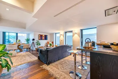 a living room with a couch and a table at Skylife Tiber Luxury Penthouse in Rome