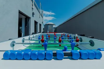a ping pong table with blue and red balls on it at Skylife Tiber Luxury Penthouse in Rome