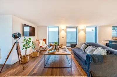 a living room with a couch and a table at Skylife Tiber Luxury Penthouse in Rome