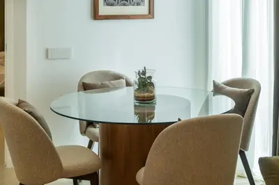 a glass table in a room with chairs at Skylife Minimalist Boutique Apartment in Rome