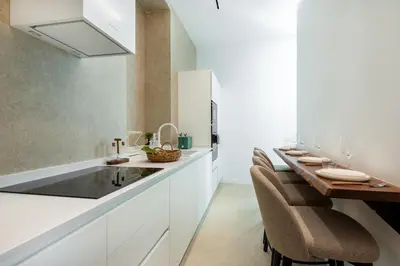 a kitchen with a sink and a long table at Skylife Minimalist Boutique Apartment in Rome