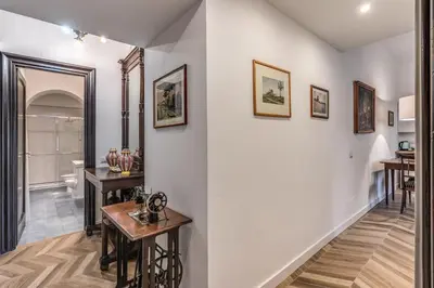 a hallway with white walls and a table at Casa Belle Arti in Rome