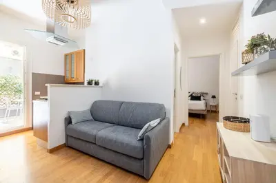 a living room with a couch and a kitchen at Casa Girasole in Rome