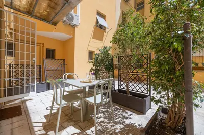 a patio with a table and chairs in a building at Casa Girasole in Rome