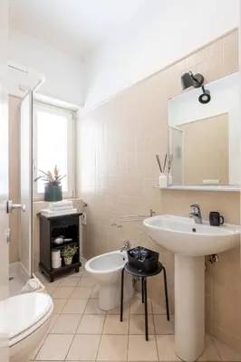 a bathroom with a sink and a toilet and a mirror at Casa Girasole in Rome