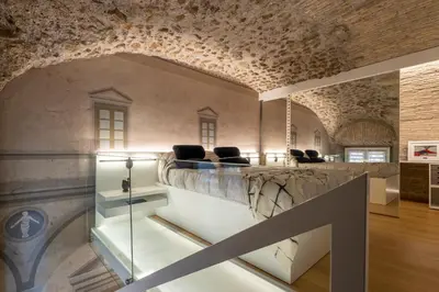 a room with a stone counter with chairs on it at Spagna Suite Luxury Home - Trevi Fountain in Rome