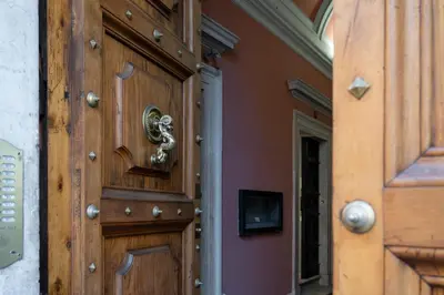 a wooden door with a brass knocker on it at Spagna Suite Luxury Home - Trevi Fountain in Rome