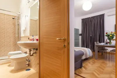 a bathroom with a toilet and a sink at Vatican Loris House in Rome