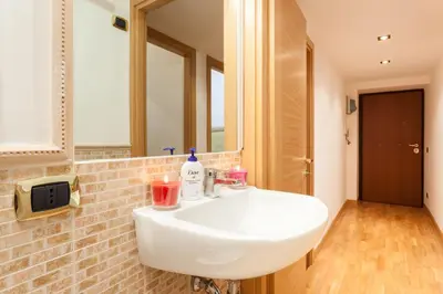 a bathroom with a white sink and a mirror at Vatican Loris House in Rome