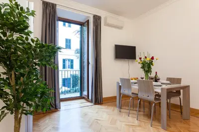 a dining room with a table and chairs and a window at Vatican Loris House in Rome