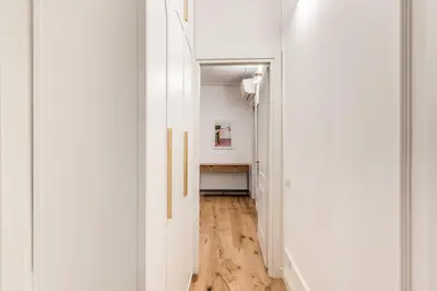a hallway with white walls and a wooden floor at Silent 2 Bdrm heart of Trastevere in Rome