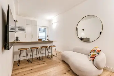 a living room with a chair and a mirror at Silent 2 Bdrm heart of Trastevere in Rome