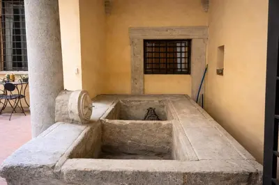 a large stone bowl in the corner of a building at Piazza Navona Historic Escape in Rome