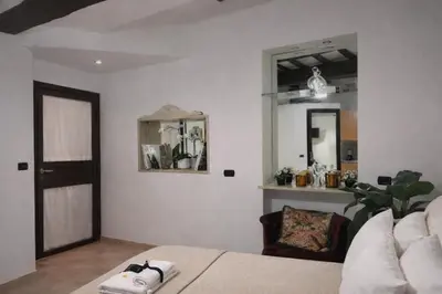 a living room with a couch and a mirror at Piazza Navona Historic Escape in Rome