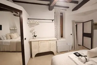 a bedroom with two beds and a bathroom with a tub at Piazza Navona Historic Escape in Rome