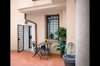 a balcony with a table and chairs in a house at Piazza Navona Historic Escape in Rome