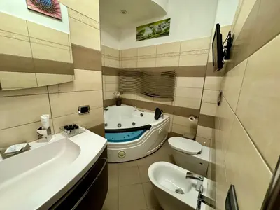 a bathroom with a sink and a toilet and a tub at Doria Boutique Apartment in Rome