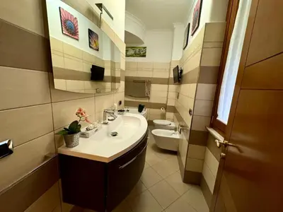 a bathroom with a sink and a toilet at Doria Boutique Apartment in Rome