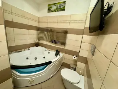 a bathroom with a bath tub and a toilet at Doria Boutique Apartment in Rome