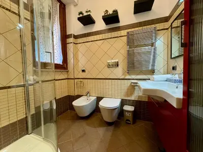 a bathroom with a toilet and a sink at Doria Boutique Apartment in Rome