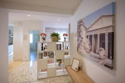 a living room with a large painting on the wall at Luxury Suite-Metro Malatesta in Rome