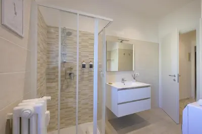 a white bathroom with a shower and a sink at Luxury Suite-Metro Malatesta in Rome