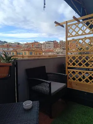a balcony with a bench and a view of a city at Trastevere Noir in Rome