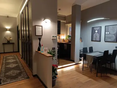 a dining room and living room with a table and chairs at Trastevere Noir in Rome