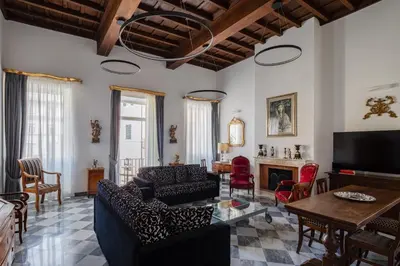a living room with a couch and a table at Luxury apartment in Trastevere San Calisto in Rome