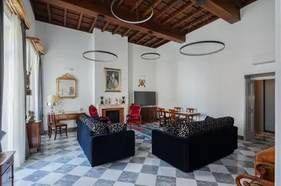 a living room with two chairs and a fireplace at Luxury apartment in Trastevere San Calisto in Rome