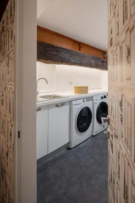 a laundry room with a washer and dryer at Luxury apartment in Trastevere San Calisto in Rome