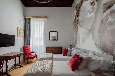 a bedroom with a bed and a desk and a couch at Luxury apartment in Trastevere San Calisto in Rome