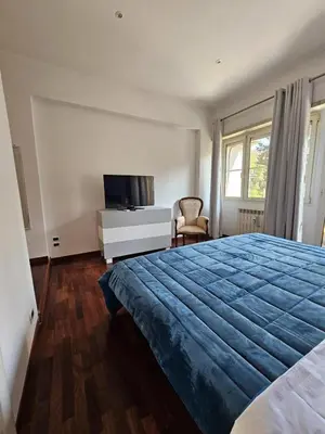 a bedroom with a large bed and a tv at A Casa di Luca in Rome